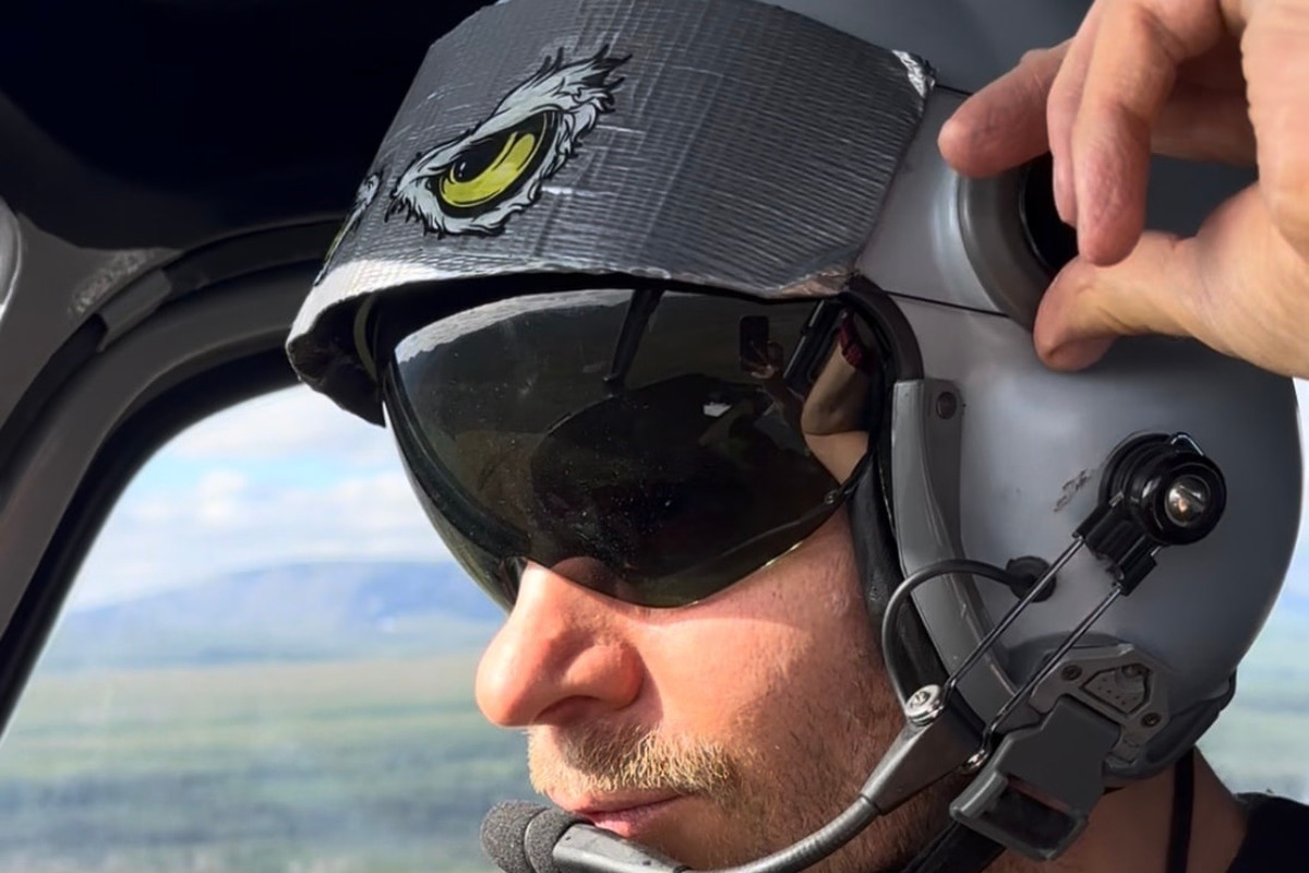 Pilot med hjelm i cockpit under oppdrag